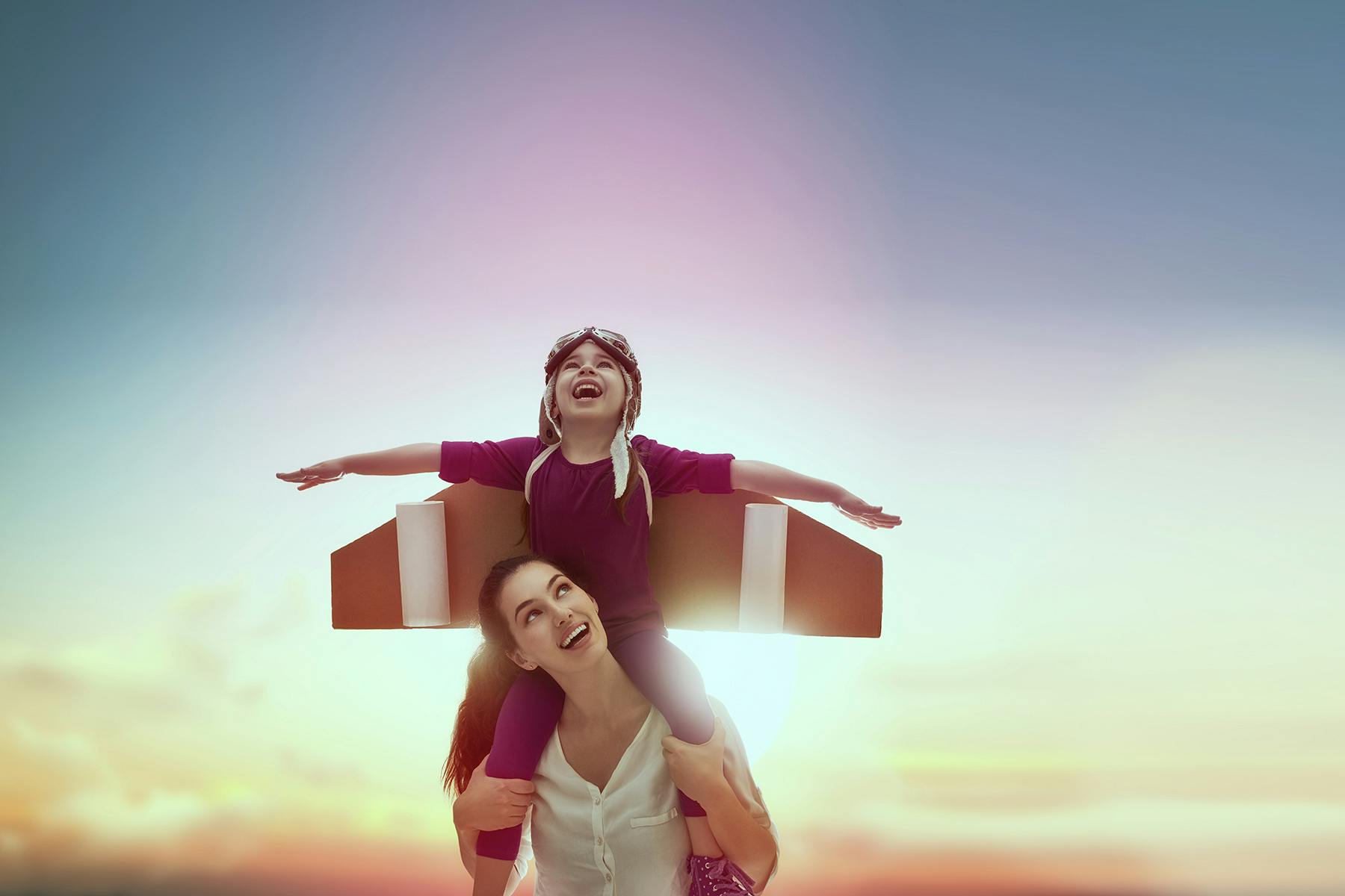 boy on woman's shoulders 